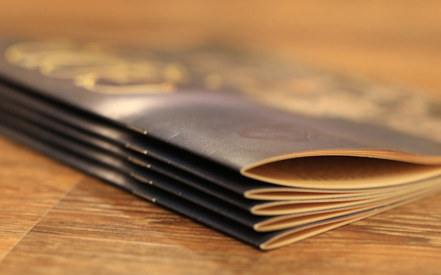 The Christmas Book in a stack on a wooden table